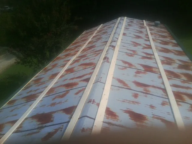 Rusted metal roof panels with new wood purlins before replacement — Storm Damage Roof Repair in Veneta by Roofing Brothers